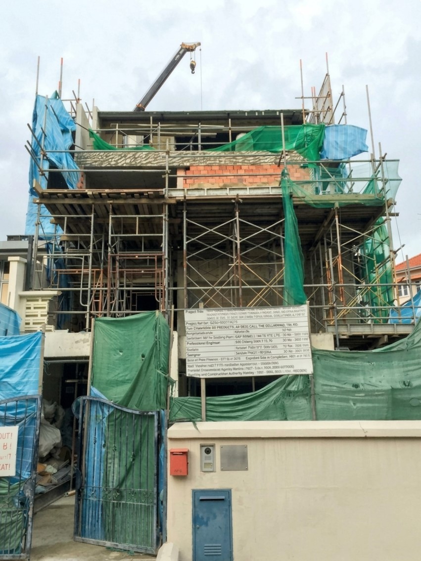 A landed house under construction with scaffolding during an A&A reconstruction.
