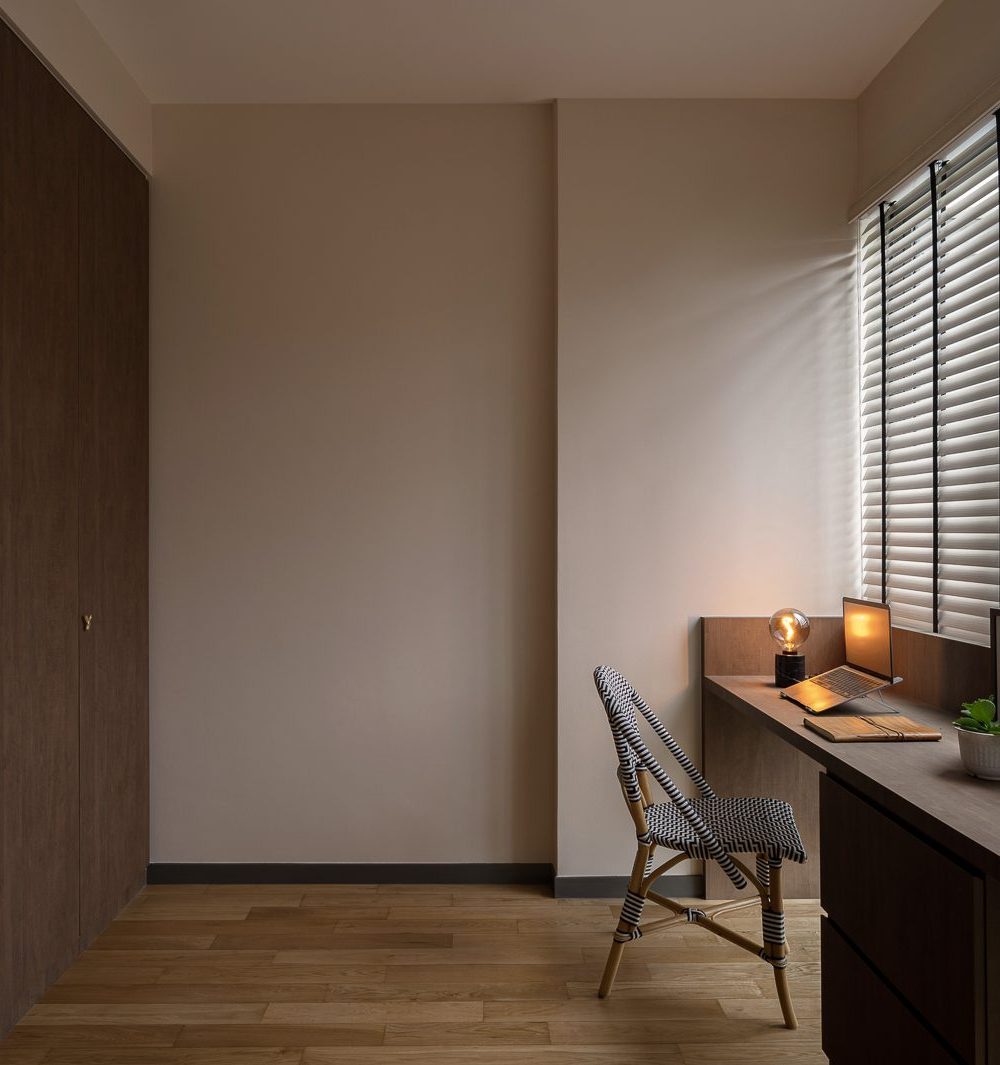 A plastered archway frames the bedroom entrance, with a gallery of photo-booth prints displayed on the corridor wall.