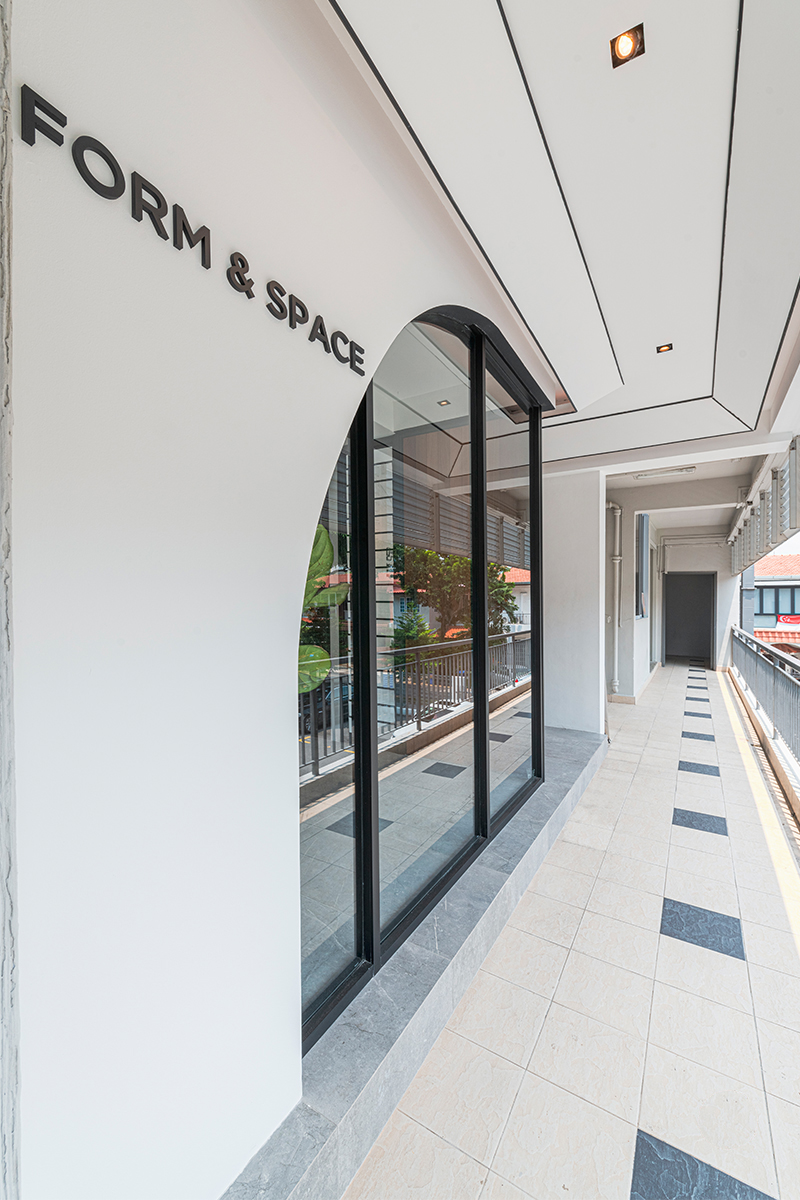 A black-framed arched glass door marks the studio's entrance, with the Form & Space name in raised lettering above.