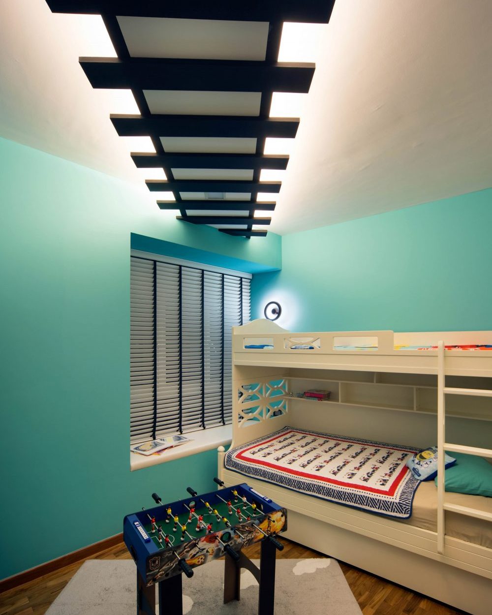 A striped, cove-lit ceiling feature runs the length of the children's room, above a built-in bunk bed with storage shelving.