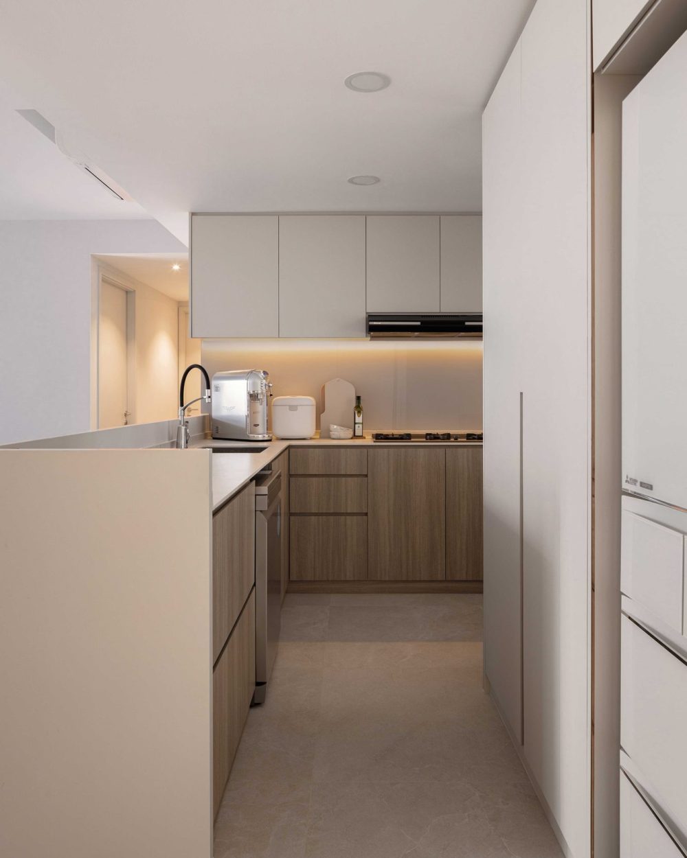 Everyday appliances and a chopping board sit ready on the counter, making the most of the kitchen's compact footprint.