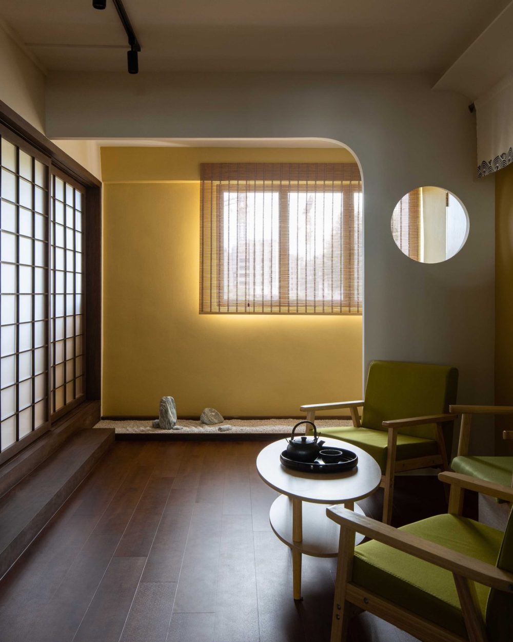 Dark timber flooring connects the tatami room, sitting nook and rock garden in one continuous, considered view.