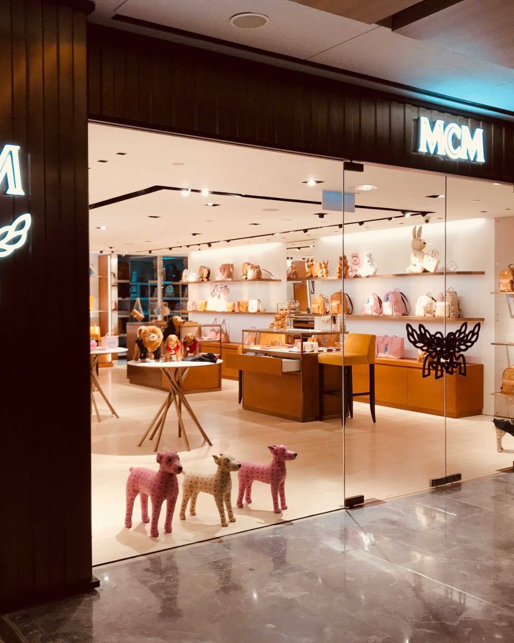 Another view of the MCM storefront showing the entrance, signage and canine figures on display.