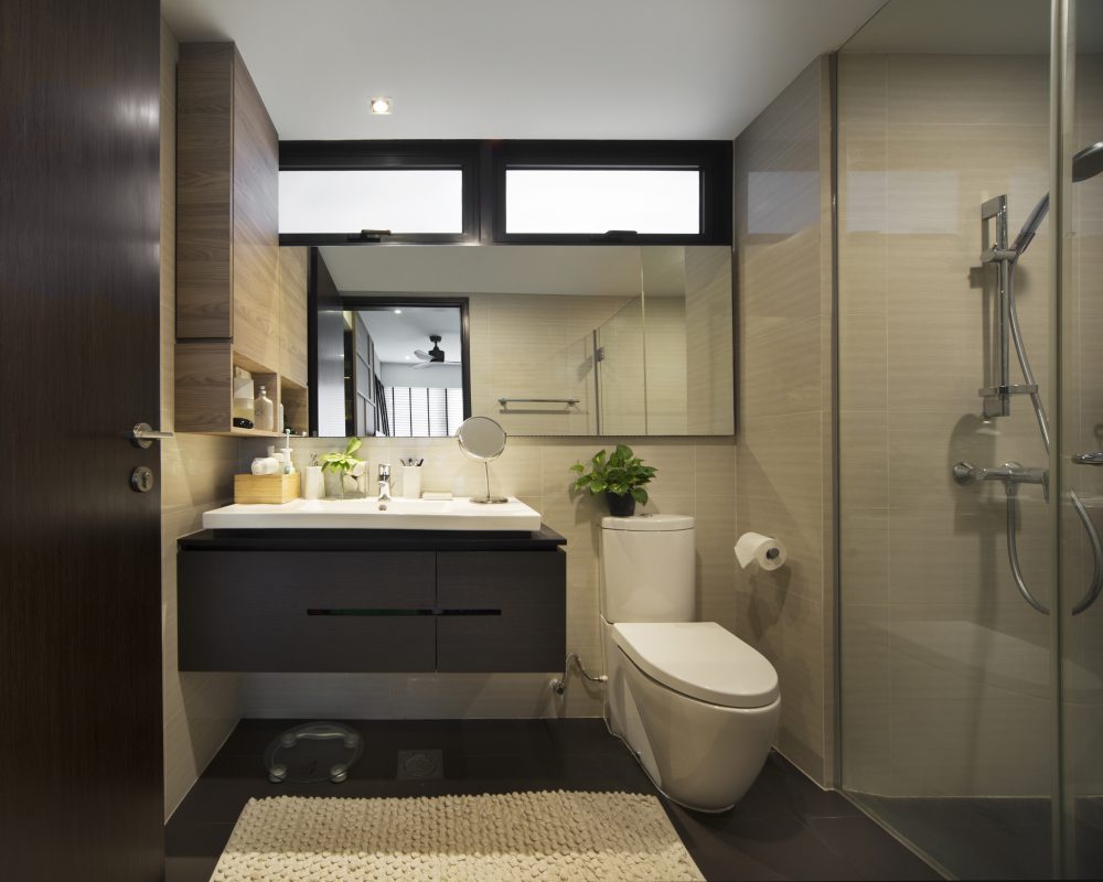 Dark timber cabinetry and a floating vanity pair with a glass-enclosed shower in the master ensuite.