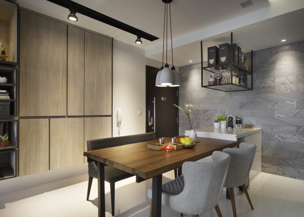 Timber cabinetry and the marble feature wall frame a dining nook that opens directly onto the kitchen counter.