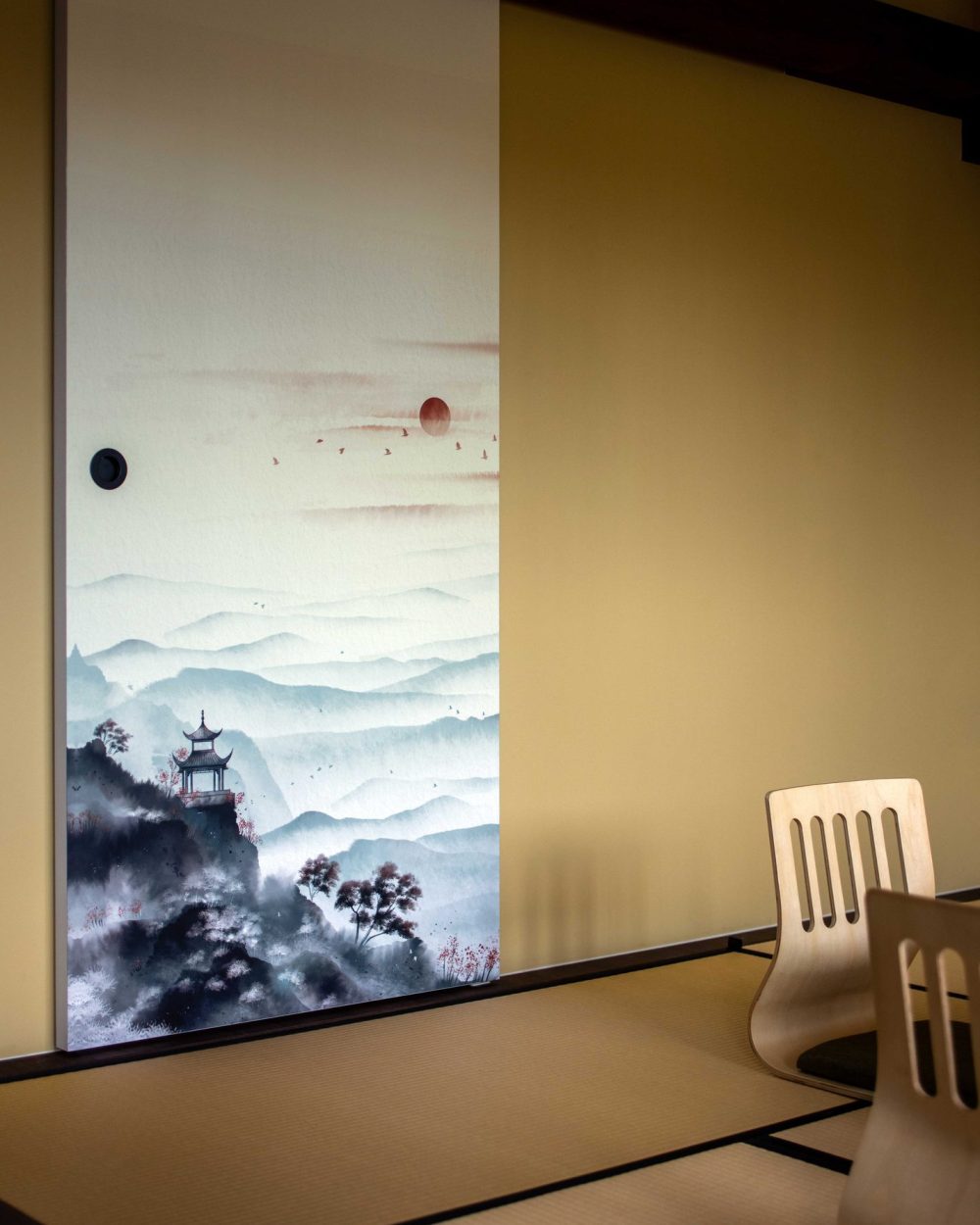 The hand-painted mural continues across the full sliding door, complete with a rising sun and a flock of birds overhead.