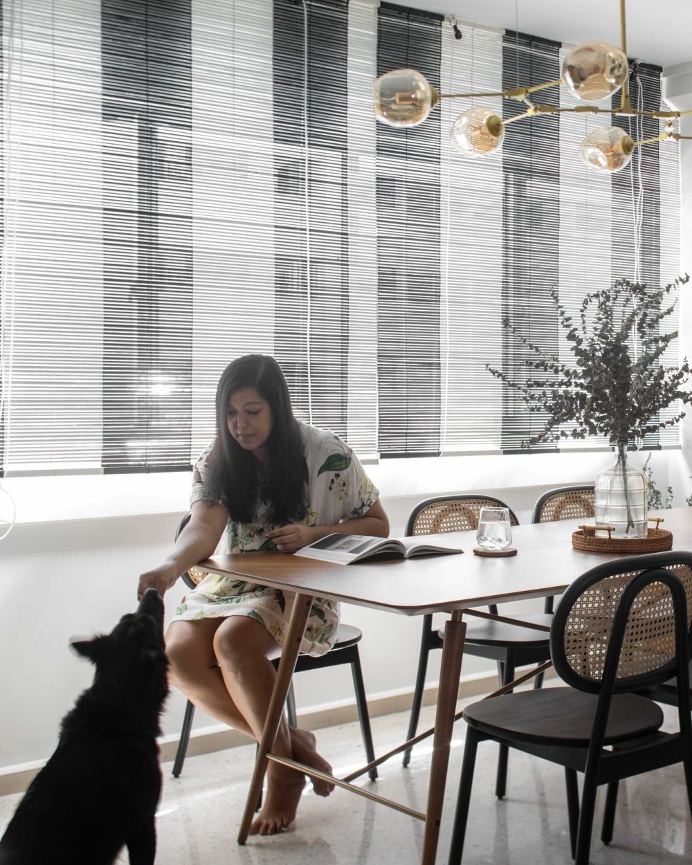 The finished dining room in everyday use, with the homeowner sharing a snack with the family dog.