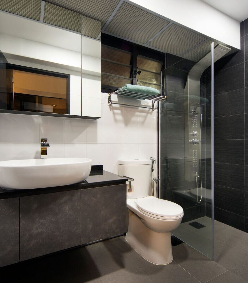 A closer look at the ensuite's shower panel, fitted with a rain shower head and multiple body jets set into dark charcoal tiling.