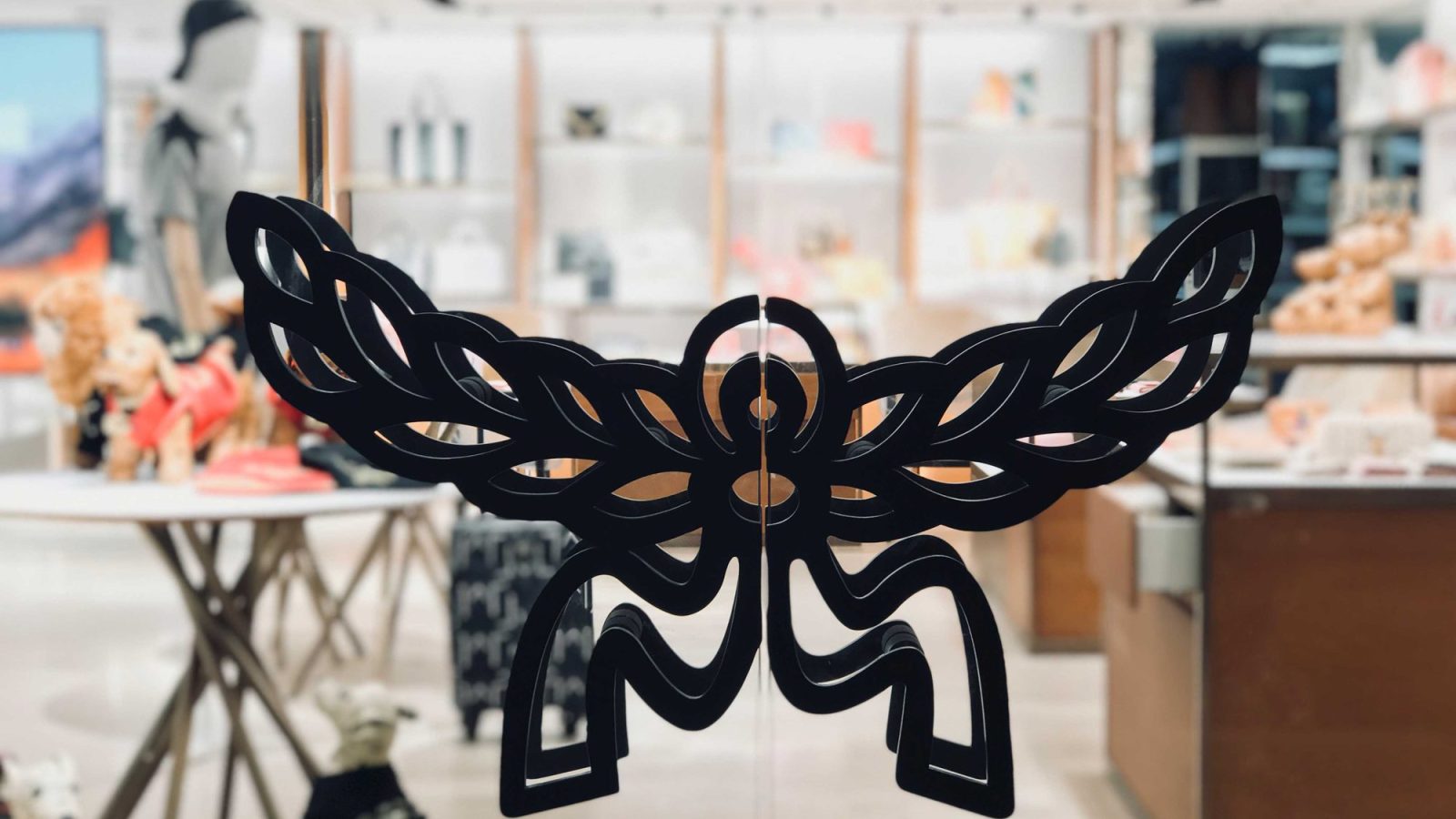 MCM's wing-and-flower brand emblem applied to the glass entrance doors at Paragon mall.