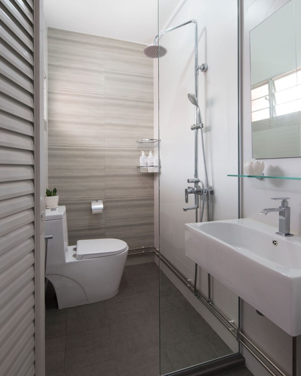 Light timber wardrobe panelling lines the corridor leading into the bedroom, keeping storage seamless and unobtrusive.