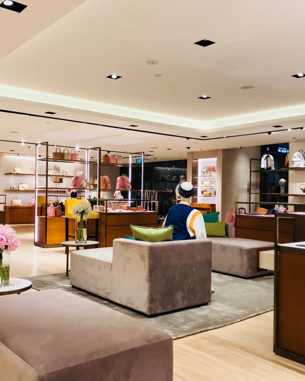 A wide view of the MCM retail floor with lounge seating, backpacks and bag displays.