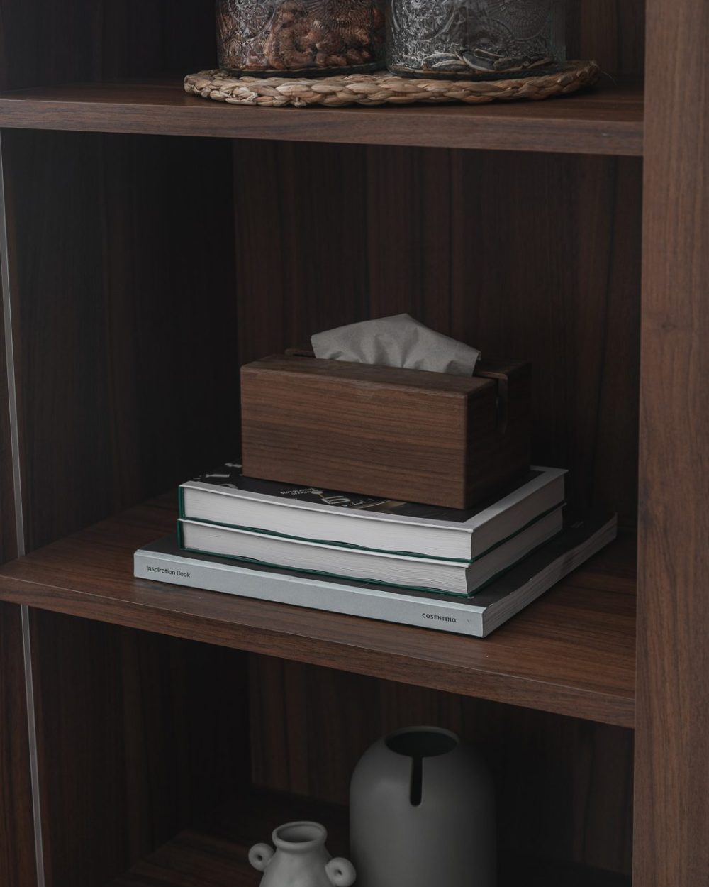 Warm walnut wardrobe panelling meets crisp white storage, with a discreet integrated door pull the only break in the surface.