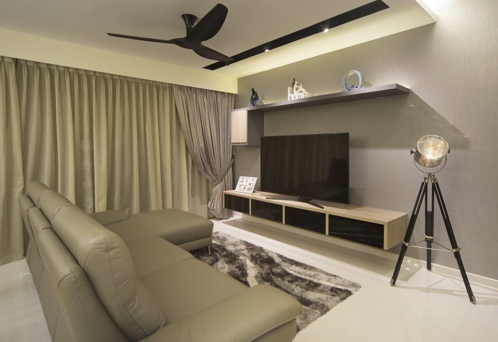 An olive leather sectional and shaggy area rug anchor the living room, paired with a floating TV console and a tripod spotlight floor lamp.