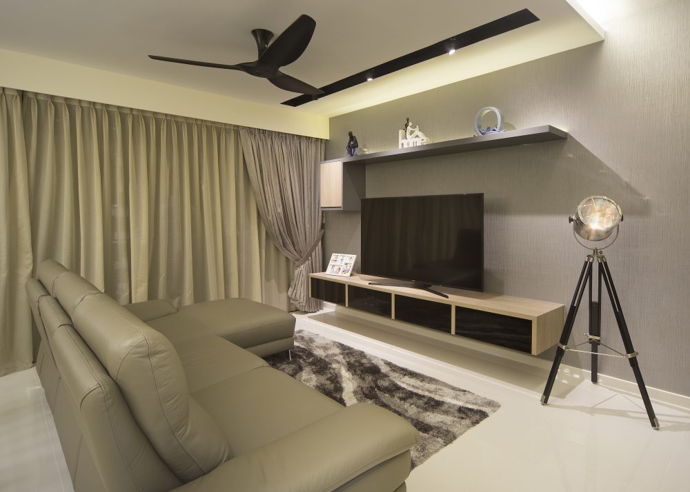 An olive leather sectional and shaggy area rug anchor the living room, paired with a floating TV console and a tripod spotlight floor lamp.