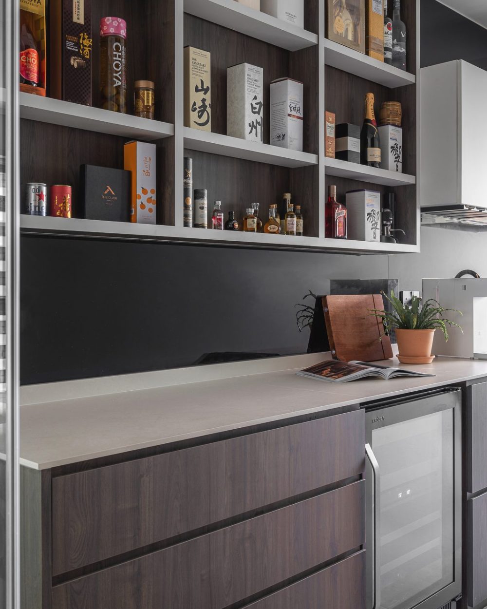Champagne, whisky and liqueurs fill the illuminated bar shelving, with a wine chiller built in below the counter.