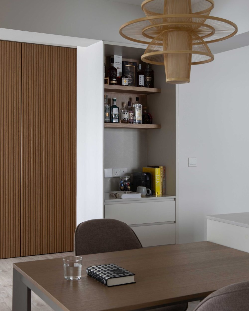 A closer look at the bar nook's curated collection of whisky and gin, lit from within by warm LED shelving.