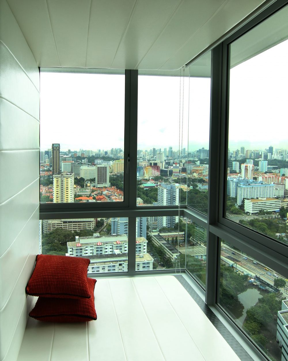 A built-in, upholstered window bay seat looks out over the skyline — a quiet spot to sit back and take in the view.